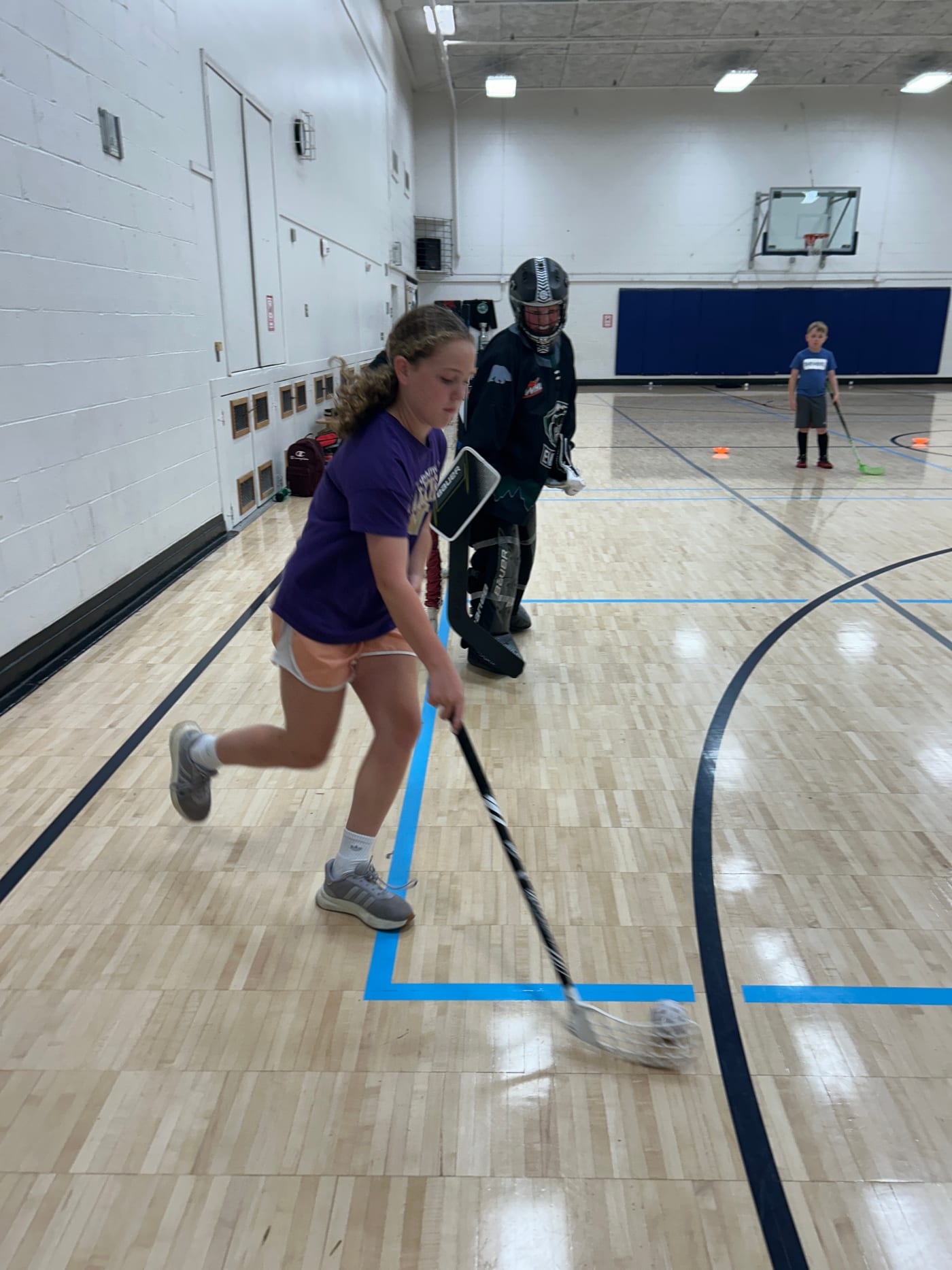 Fast-paced ball hockey game during Edmonds Summer Camp