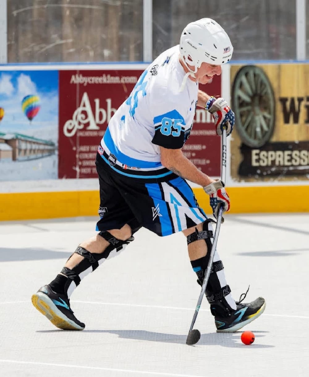 Coach Salvatore playing ball hockey in full gear