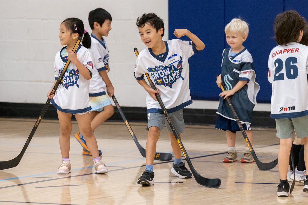 Young Emerald City Ball Hockey players on the floor