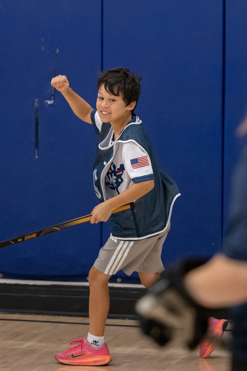 A young Emerald City Ball Hockey player celebrating