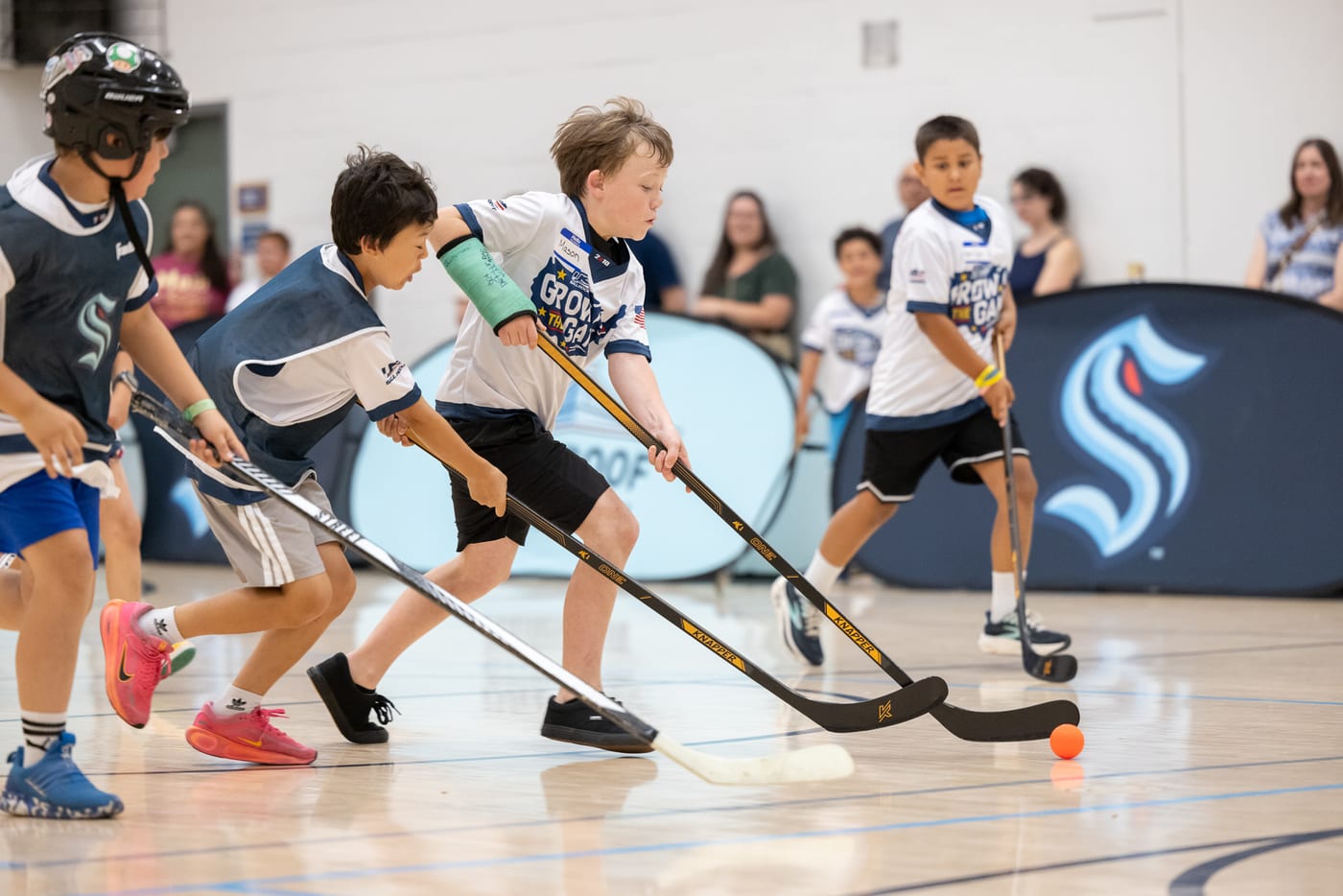 Kids battling for the ball during an Emerald City Ball Hockey game